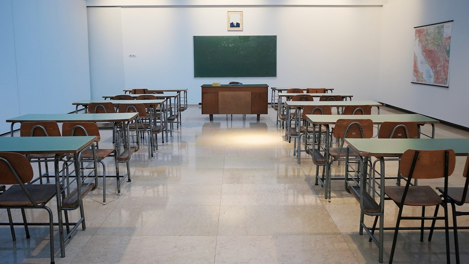 Bright elementary classroom with desks and chairs
